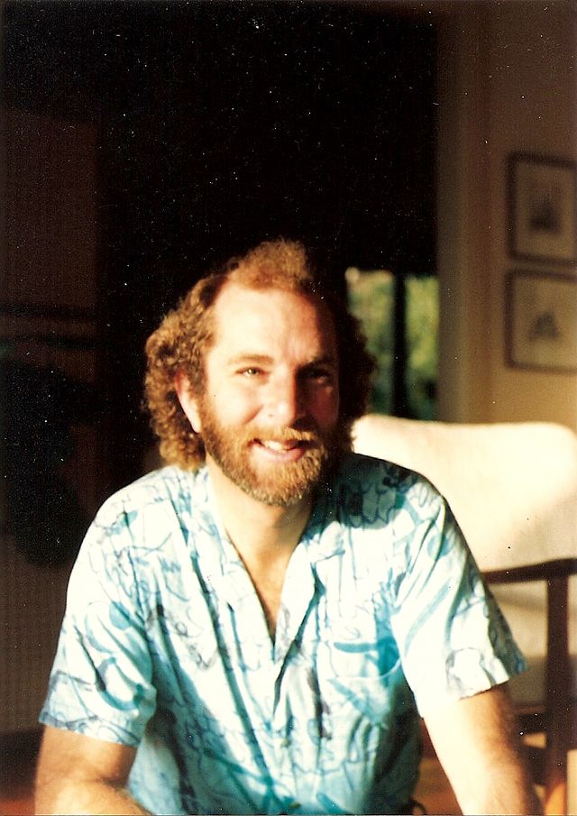 Bob smiling in a patterned shirt